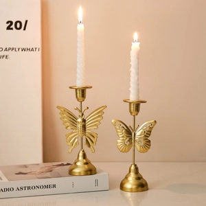 Golden butterfly metal candle holders in a minimalist luxury European style home decor
