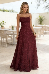 Detail of burgundy floral jacquard long dress featuring thin straps and pleated hem
