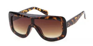 Detail view of tortoiseshell oversized shield sunglasses with gradient brown lenses