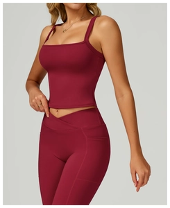 Detail of burgundy yoga set featuring cross-waist leggings with pockets and thin strap vest