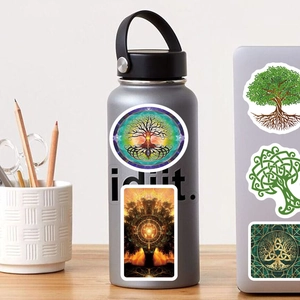Waterproof Tree of Life stickers applied on a grey water bottle and silver laptop