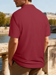 Detail view of burgundy waffle knit texture and tailored back fit on a men polo shirt