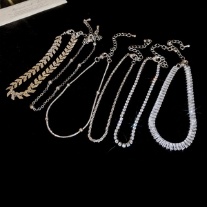Detailed view of silver charm bracelet set with sparkling cubic zirconia and lobster clasps