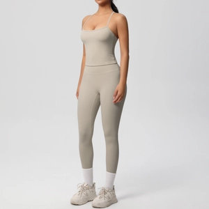Side view of beige yoga set featuring high-waisted leggings and slim strap sports tank top