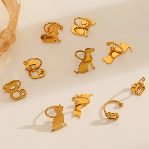 Golden stainless steel animal ear clips with hollow cat and dog paw designs for women