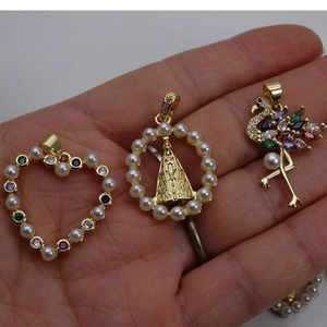 Gold pendants with pearls and zircons in heart, religious icon, and flamingo designs
