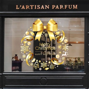Close-up of golden Christmas wreath window decal with Merry Christmas and Happy New Year text