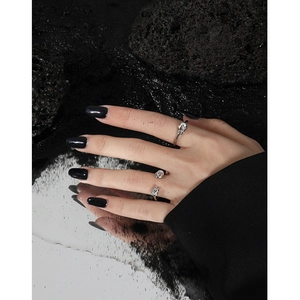 Minimalist S925 sterling silver knot ring for women on aesthetic volcanic stone background