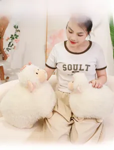 Detail of plush lamb dolls in two sizes featuring curly fleece and cute closed-eye embroidery