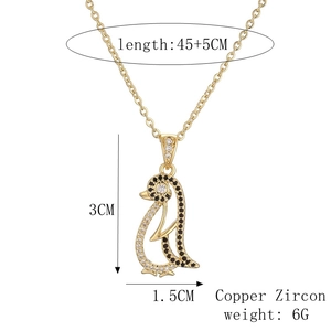 Detail view of a gold penguin pendant with zircon stones showing size 45+5cm and 6g weight