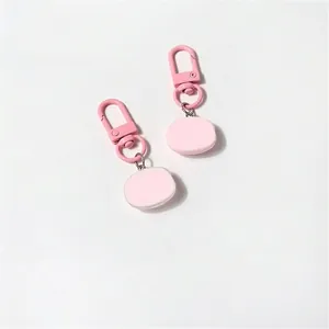 Set of two cute pink pig keychains featuring smooth flat pendants and metal spring clasps