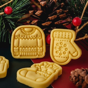 Christmas cookie cutters set featuring festive sweater, glove and sock shapes for DIY baking