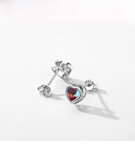 Détail de boucles d'oreilles cœur en argent 925 avec pierres irisées colorées