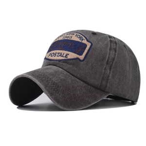 Detailed view of New York 1865 embroidery on dark grey washed cotton baseball cap