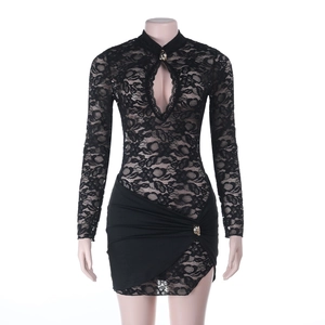 Détail d'une mini-robe en dentelle noire avec découpe et jupe drapée asymétrique