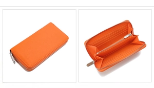 Close-up of orange litchi grain leather wallet showing interior slots and zip pocket