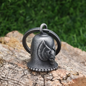 Detailed close-up of vintage silver motorcycle guardian bell with eagle wing relief