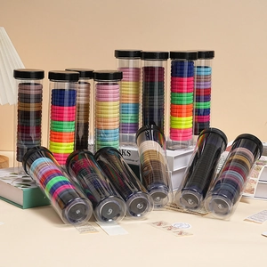 Macro shot of colorful high-elastic hair ties in a clear cylindrical storage tube