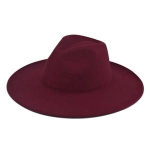 Detail of burgundy wool felt wide brim hat featuring a decorative metal chain strap