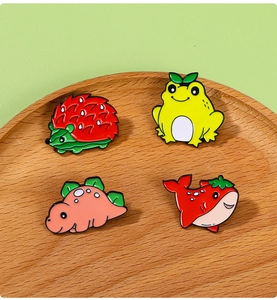 Detailed view of cute enamel strawberry-themed hedgehog, frog, dinosaur, and whale pins