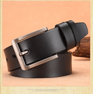 Detail of black leather men's belt with vintage silver brushed metal pin buckle
