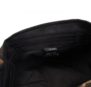 Close-up of vintage newsboy cap interior showing black lining, sweatband and care label