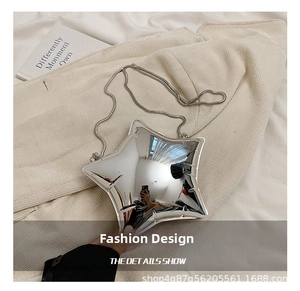 Detail showing the shiny mirror silver star-shaped metallic crossbody bag with chain strap