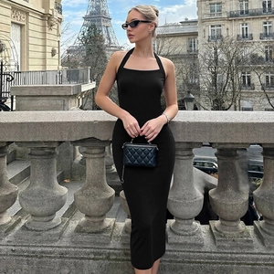 Detail of black ribbed knit fabric and halter neckline on a slim fit backless dress