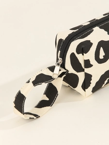 Close-up of black and white animal print canvas bag with durable zipper and carry handle