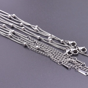 Detail of 1.5mm stainless steel ball chains with lobster clasps and extension tags