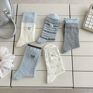 Five pairs of cream and blue cotton mid-calf socks with heart and bow embroidery