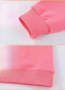 Macro detail of ribbed cuffs and hem stitching on pink cotton sweatshirt for girls