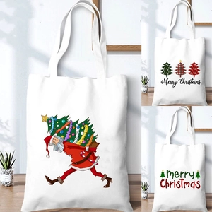 White canvas Christmas tote bag featuring Santa Claus and tree print for holiday shopping