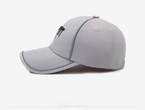 Detail of light gray quick-dry baseball cap featuring black letter embroidery on the side