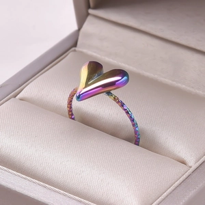 Macro shot of rainbow gradient heart ring with faceted texture in a jewelry box