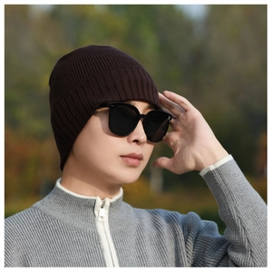Detail of dark brown ribbed knit beanie with thick thermal texture for winter styling