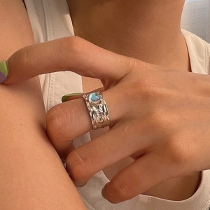 Irregular silver textured ring with moonstone center in a minimalist aesthetic