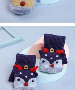 Close-up of knit reindeer gloves with plush cuffs and 3D red nose detail for children