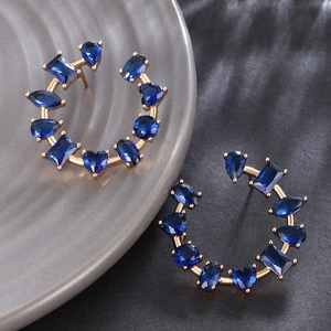 Elegant gold earrings with asymmetrical dark blue heart and oval zircon stones