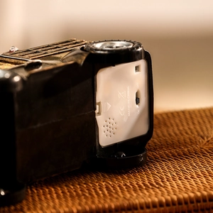 Detailed bottom view of vintage car music box showing battery compartment and power switch