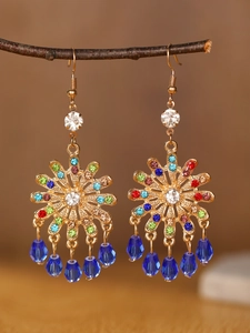 Detail of bohemian drop earrings with colorful crystals and blue teardrop beads