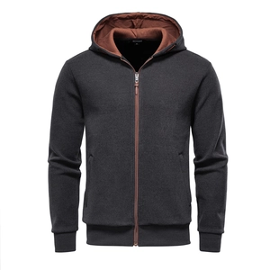 Macro detail of men's fleece-lined hoodie showing zipper texture and brown inner lining