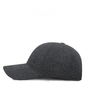 Detailed side view of thick wool blend winter baseball cap with metal logo badge