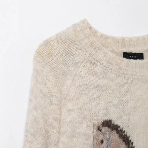 Beige wool blend knit sweater with classic crew neck and detailed jacquard embroidery