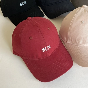 Detailed embroidery of white SUN text on twill cotton baseball cap with curved brim
