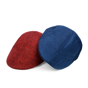 Detail of red and blue cotton linen flat caps with breathable woven texture details