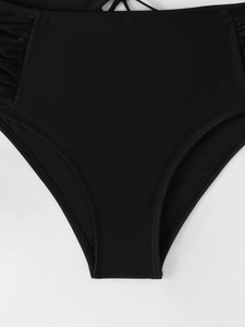Close-up of high-waisted black bikini bottoms with ruched sides and lace-up detail