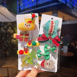 Close-up of festive Christmas hair clip set with reindeer and Santa Claus designs