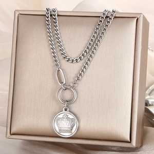 Detail of silver double-layered crown pendant necklace on a jewelry gift box