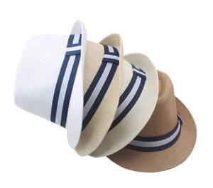 Detail of four straw fedora hats in white, beige, yellow, and brown with striped ribbons